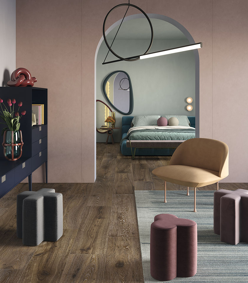 Camera da letto moderna con pavimento effetto legno, pareti rosa tenue e arredi dalle forme morbide.